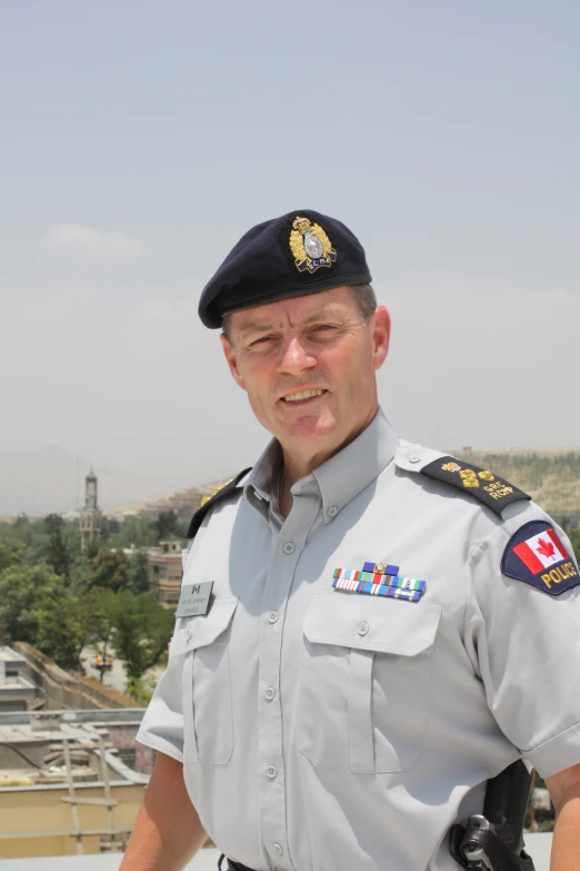 a man in a uniform with patches on his shirt