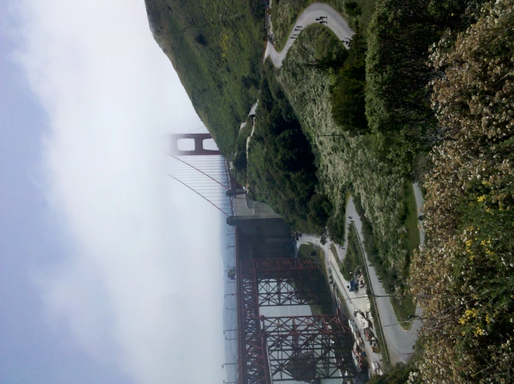 a road under a bridge is in front of the mountains