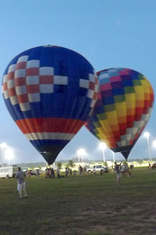 two very large balloons that are flying