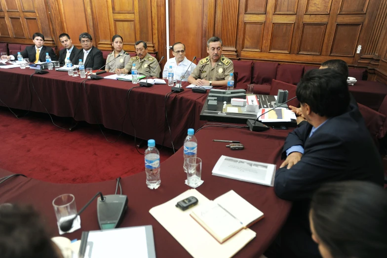 men sitting around a conference table discussing a project