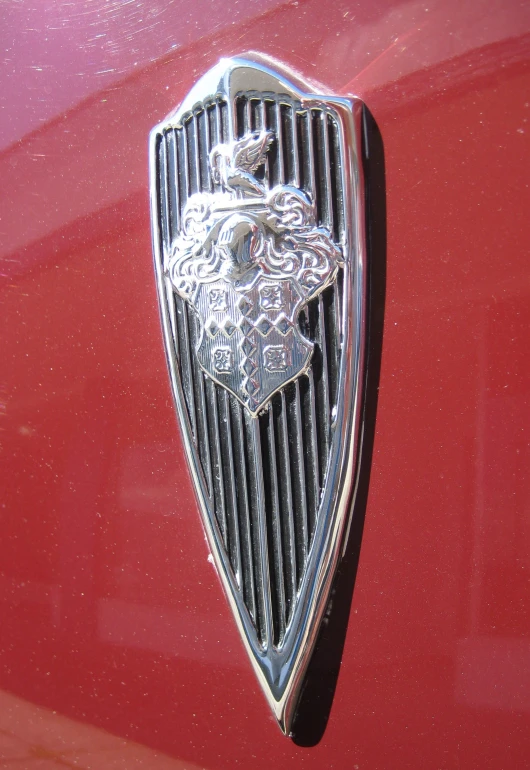 the front grill of a vintage car with an elaborate lion head on it