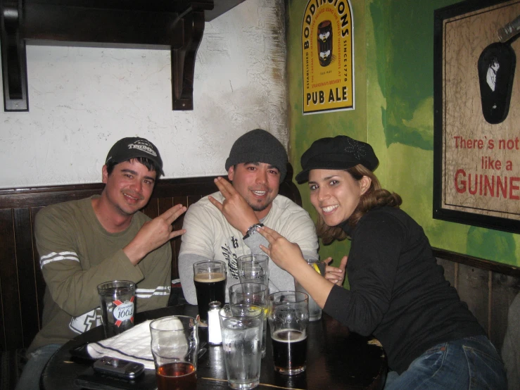 three people sitting around a table in a room