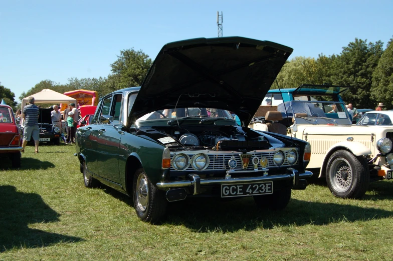 a vintage automobile is in a display with other cars