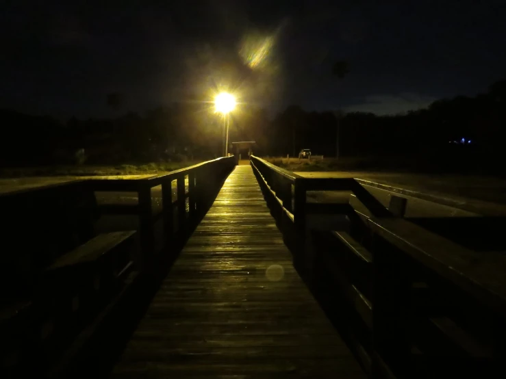 a pathway at night with light from street lamp