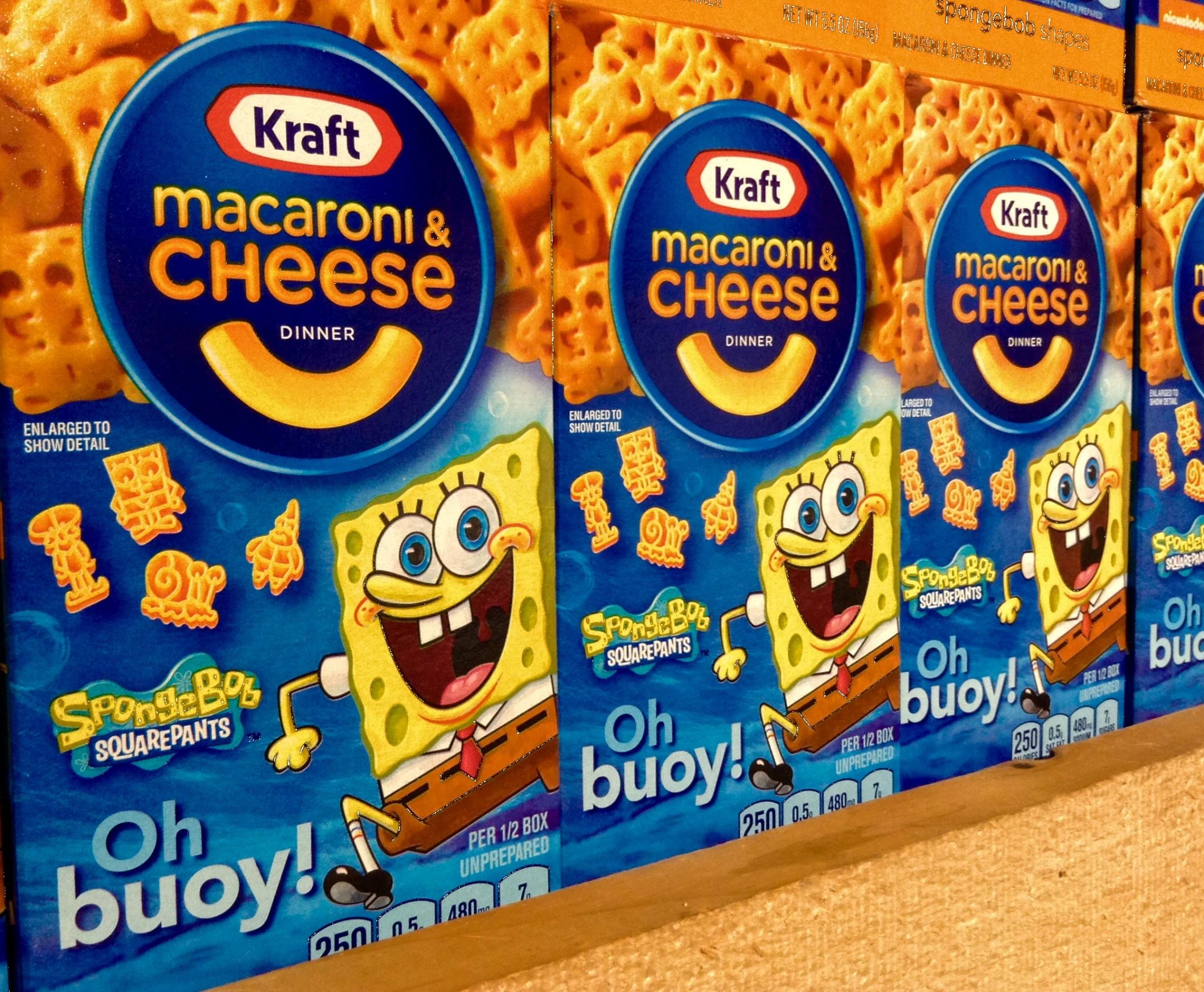 several packages of macaroni and cheese are on display