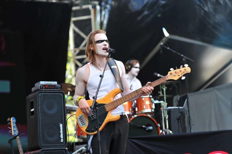 a man with sunglasses playing a guitar on stage