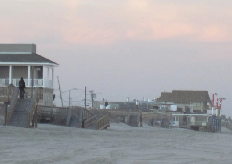 a couple walking down the boardwalk onto the ocean