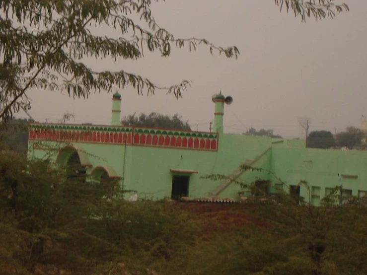 an image of a building seen through trees