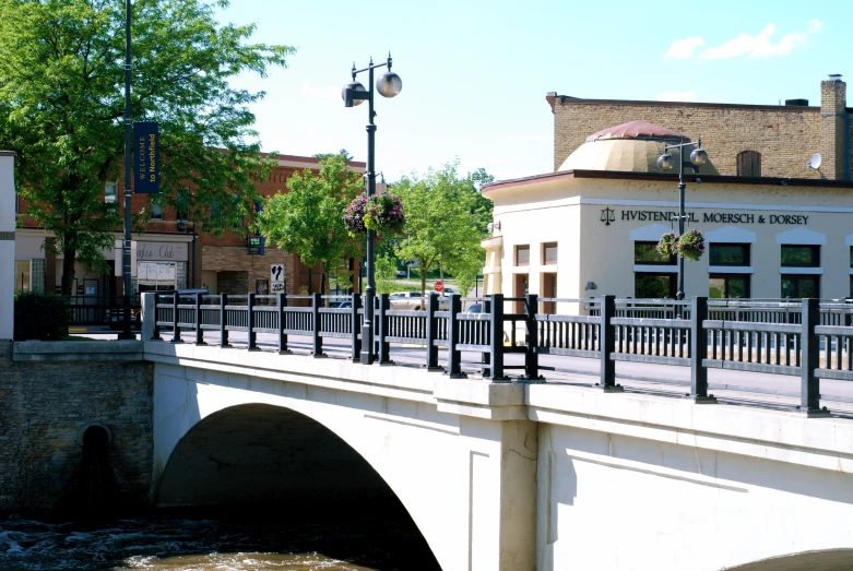 a building and bridge next to an overpass with water