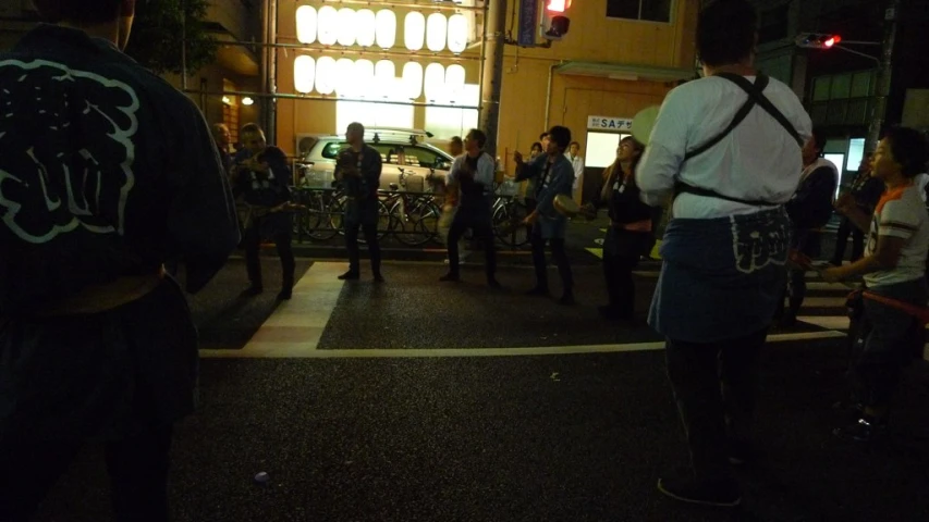 several men are standing in the street at night