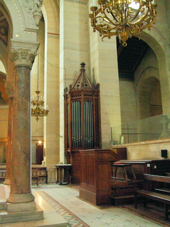 the interior of a cathedral with ornate chandelier