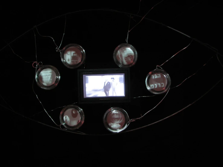 small group of different sized glass objects on top of string