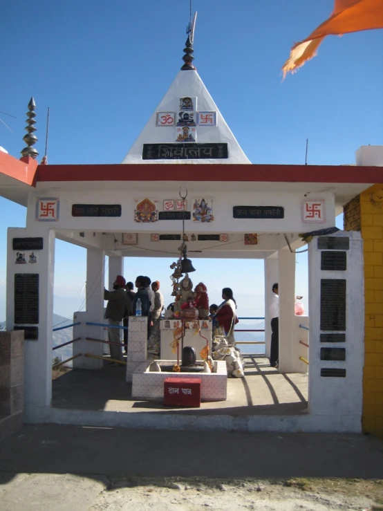 a small white structure with an open roof at the top