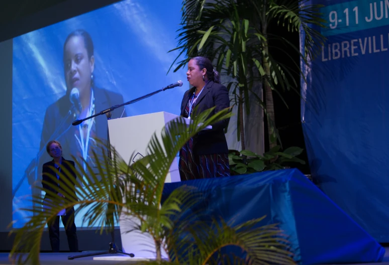 two people are speaking at a podium together