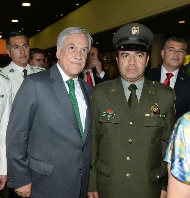 two people posing in uniforms while others watch