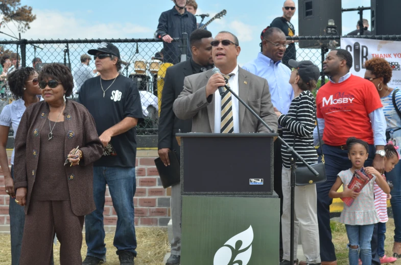 people are standing in front of a large microphone