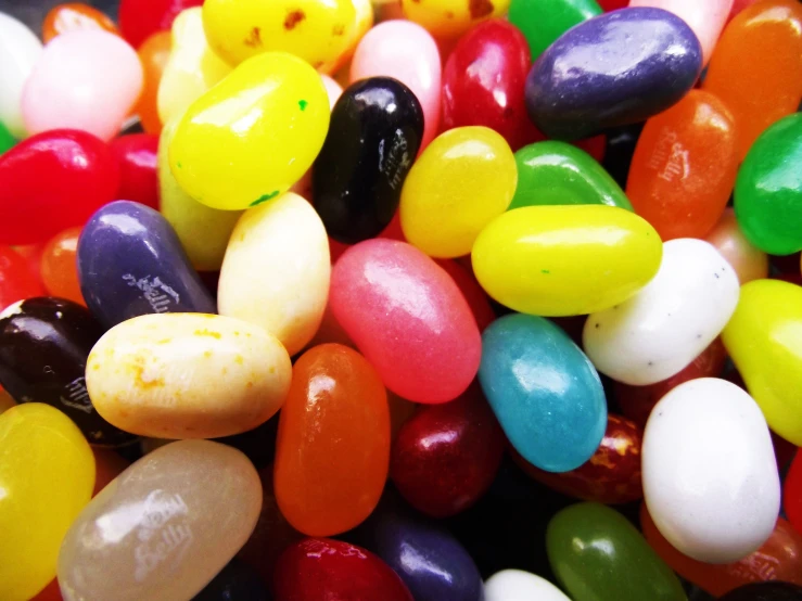 some different colored candy beans in various flavors