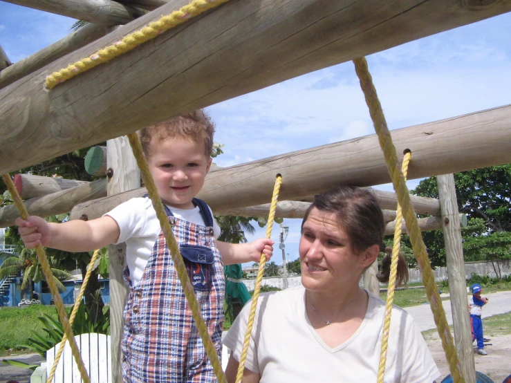 an adult and child playing in a playground