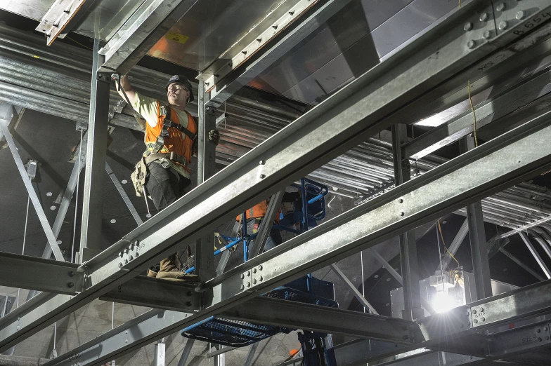 an engineer is on a metal frame working