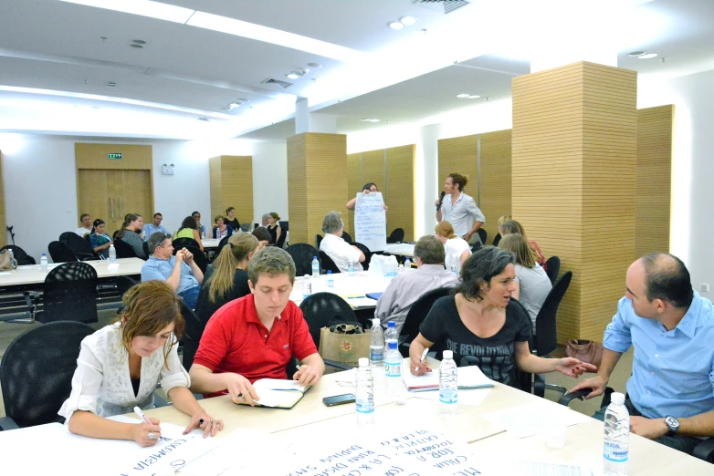 group of people working on various things in a room