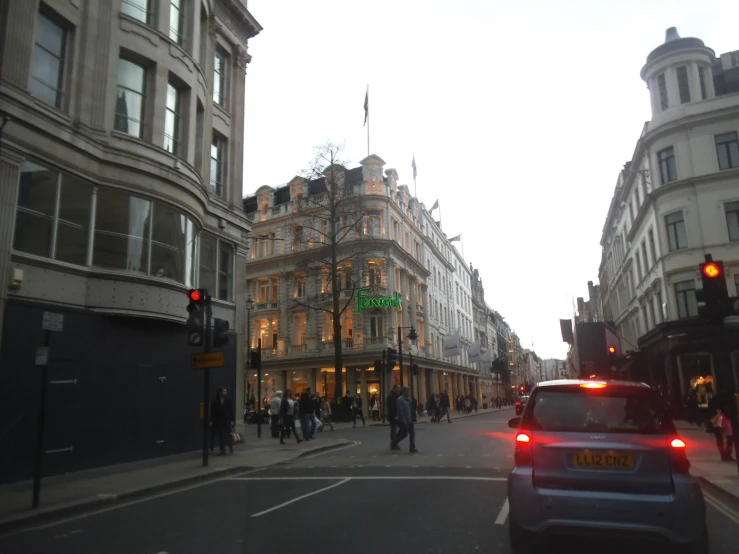 a street filled with lots of people and cars