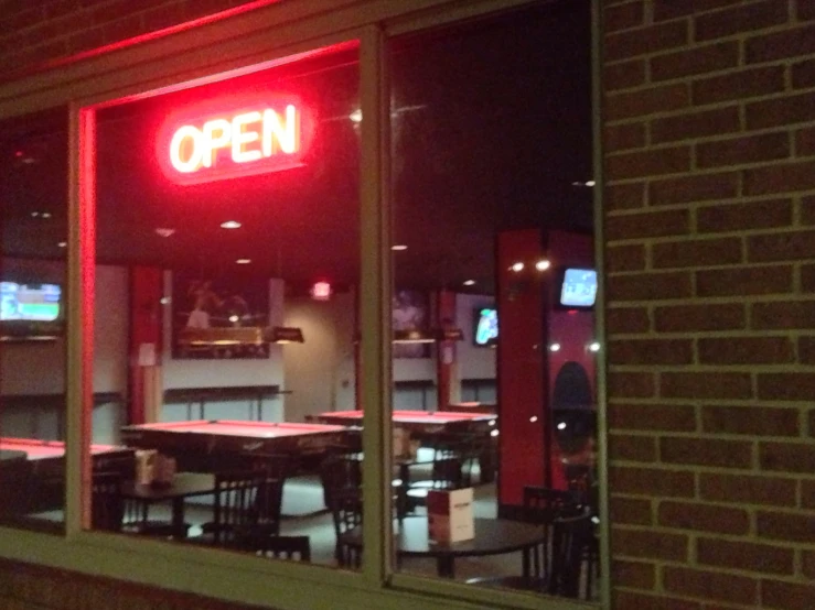 the inside of an open restaurant at night