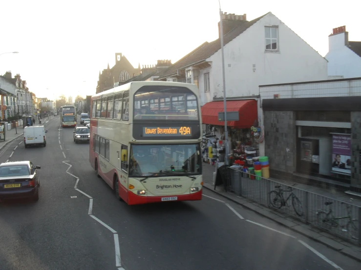 a double decker bus is going down the road