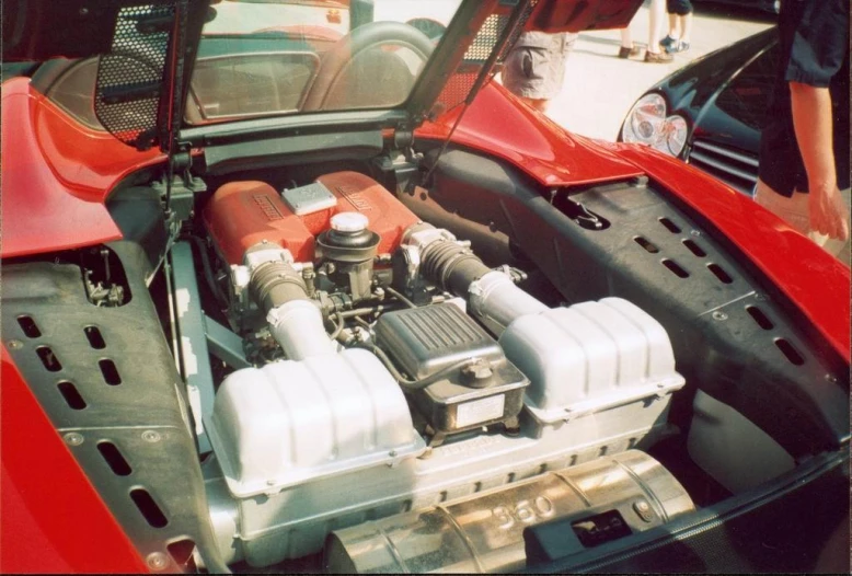 a red car with engine and hood open