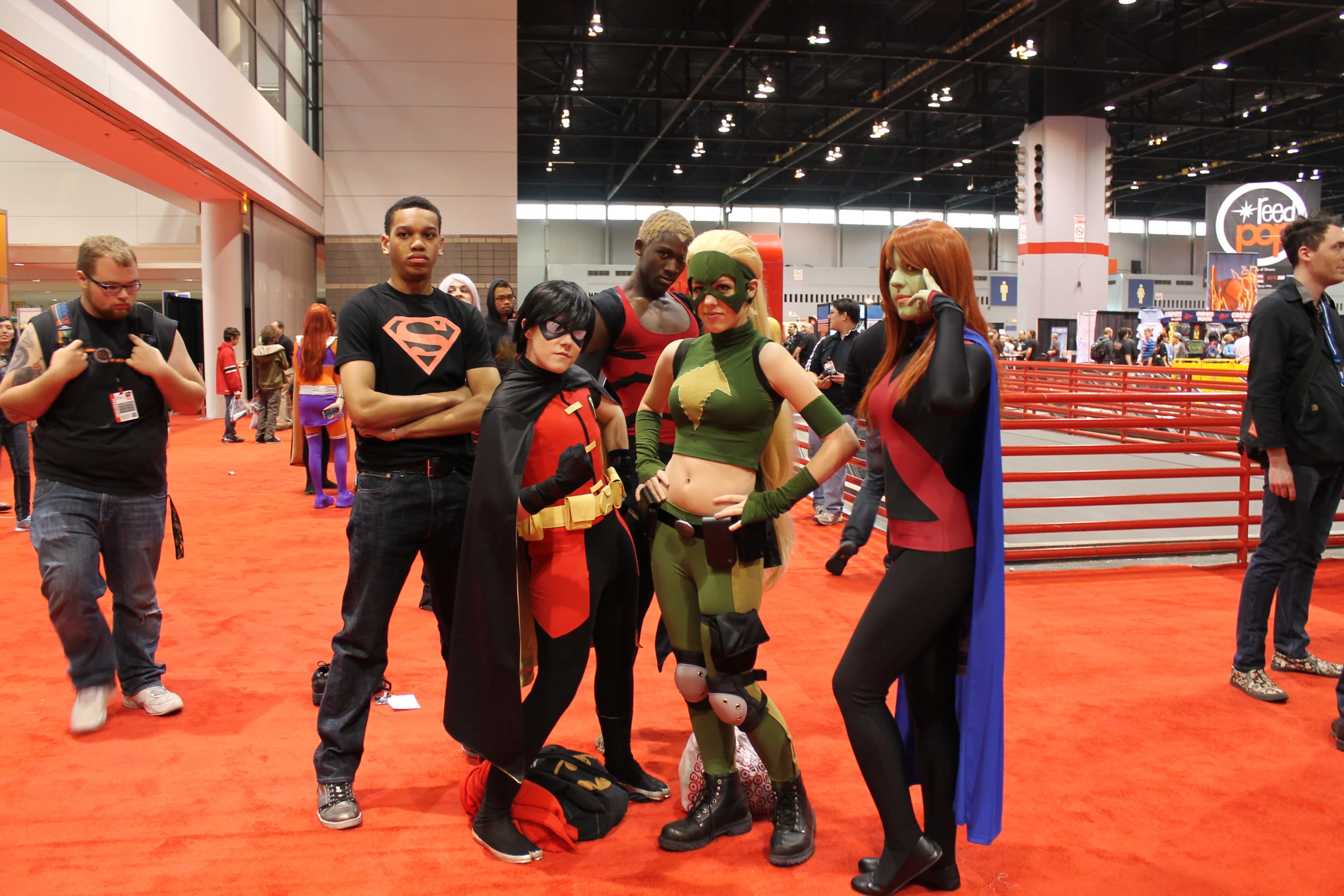 a group of people in costume standing around a booth