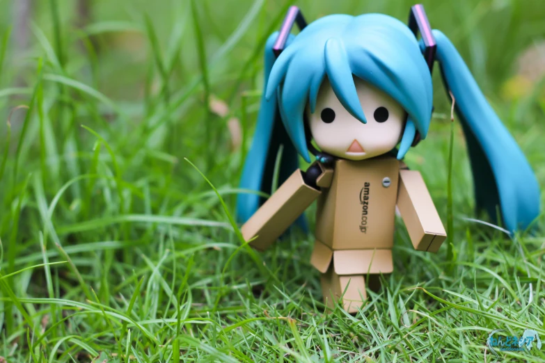 this is an image of small doll in grass