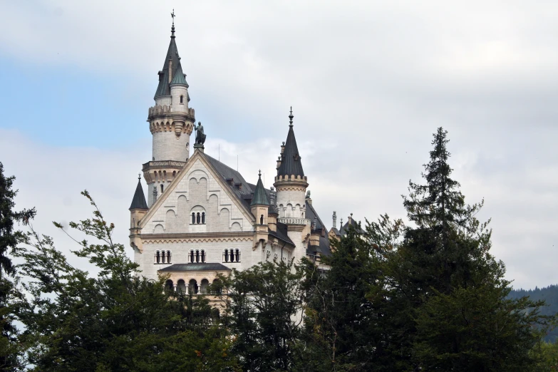 an ornate building with towers on top of trees