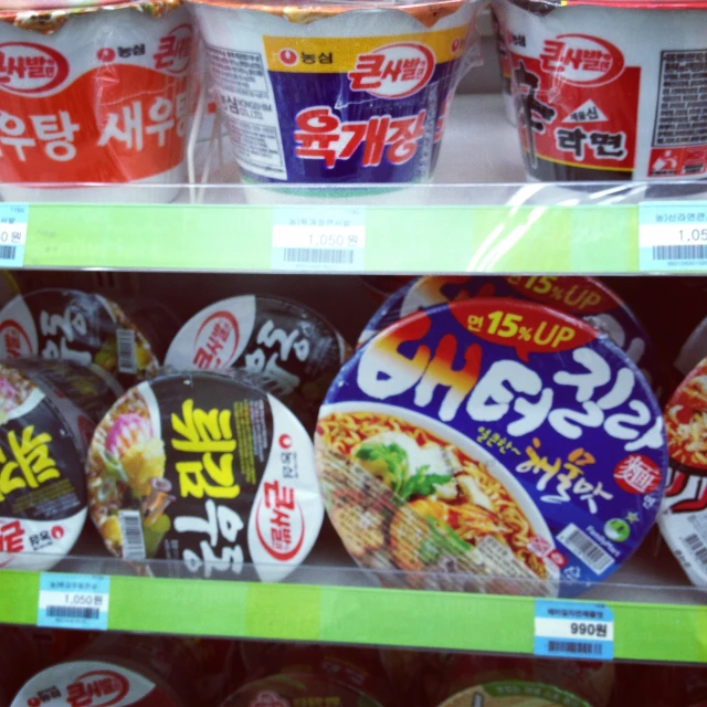 a shelf of japanese food and yogurt with various labels