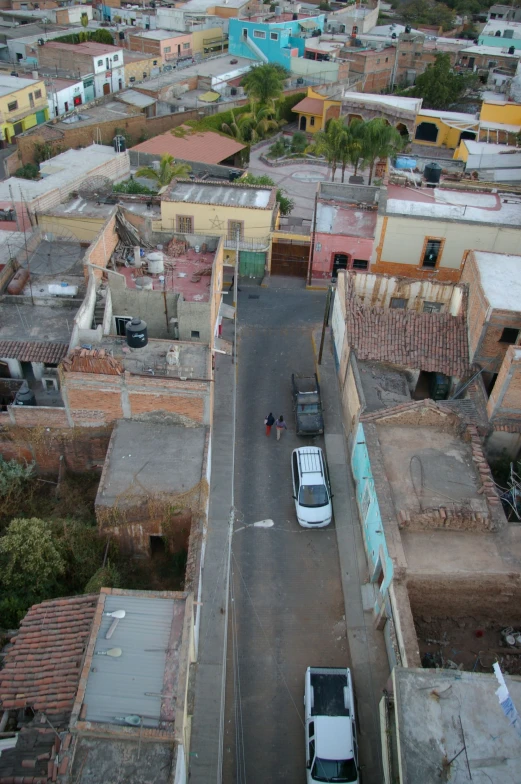 two cars parked on the street near the streets of colorful buildings