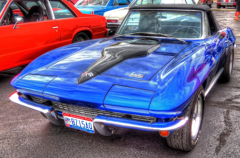 the vintage muscle car sits in the parking lot with other cars