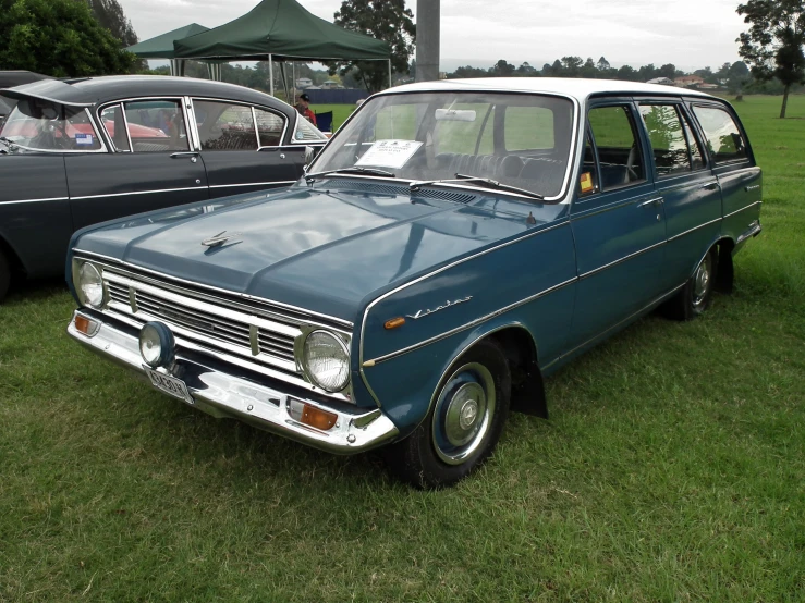 an old car on display on a grass field