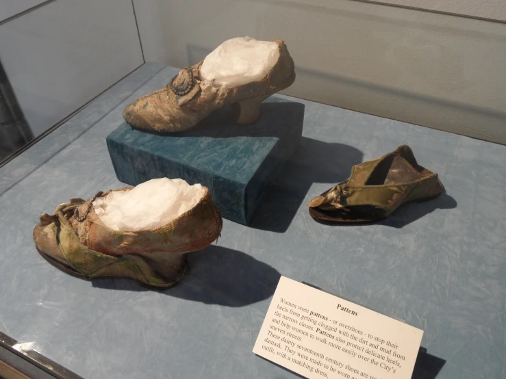 some stone shoes and a paper with a note on it