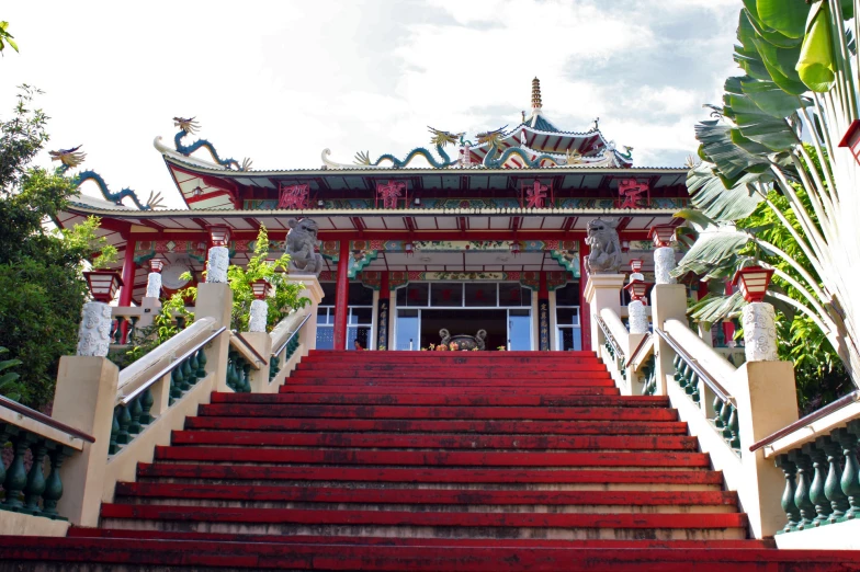 a set of steps lead up to a pavilion with decorative roof