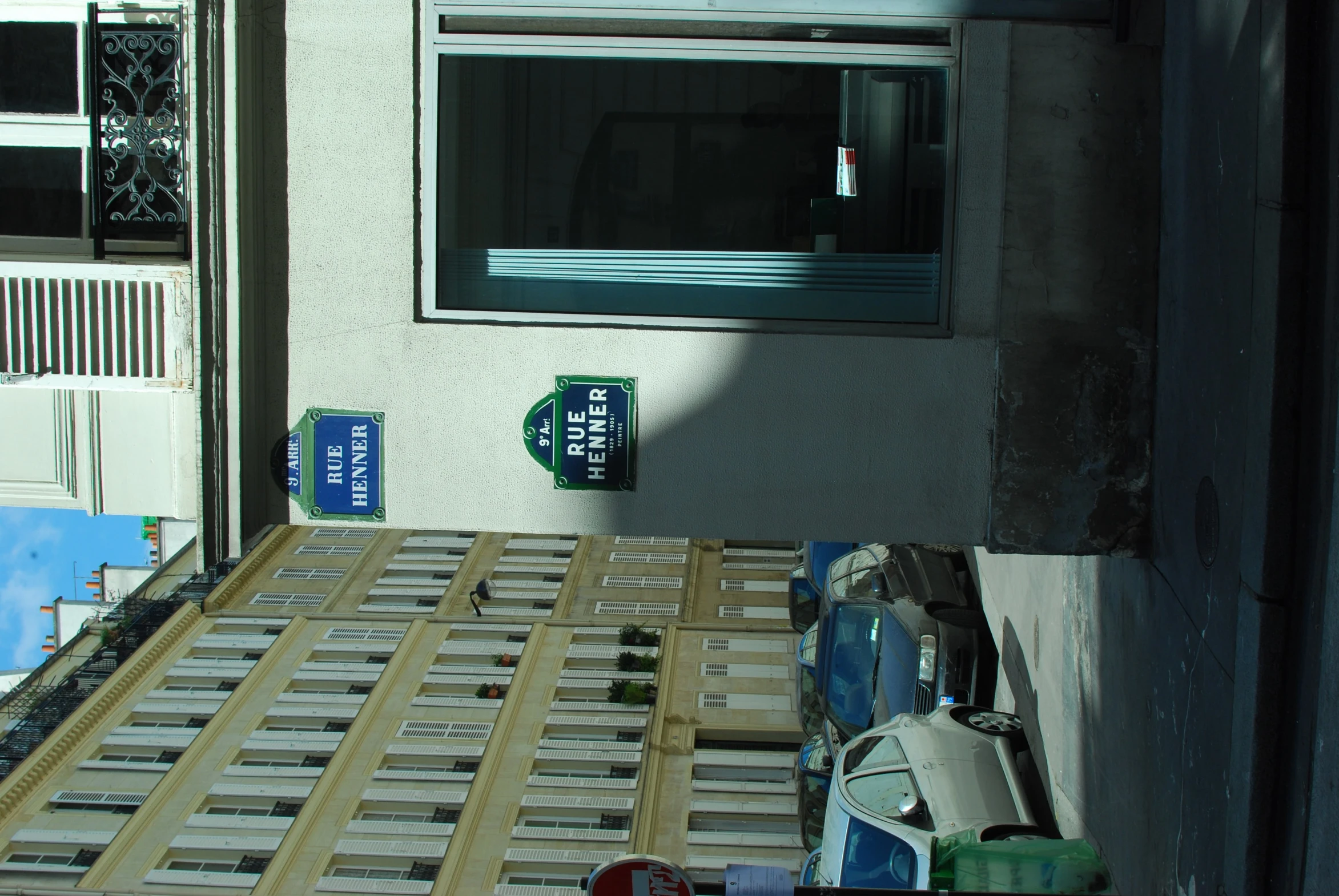 a row of parked cars in front of a small white building