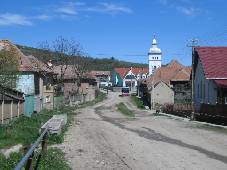 an empty street in the village with houses
