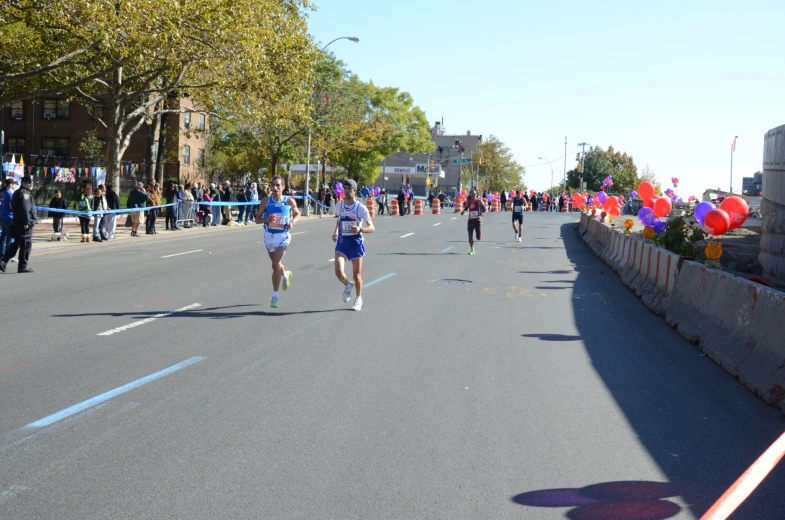 some people are running down the road during a race