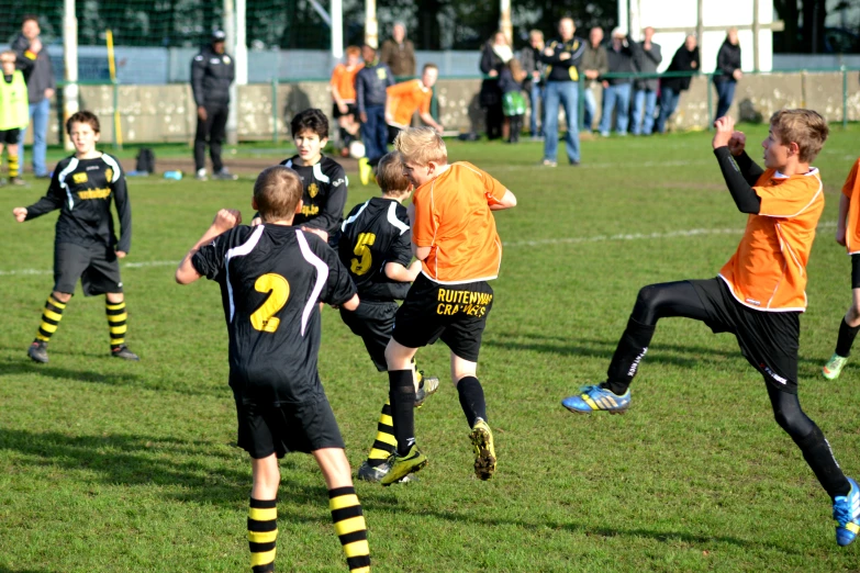 a group of young children playing a game of soccer