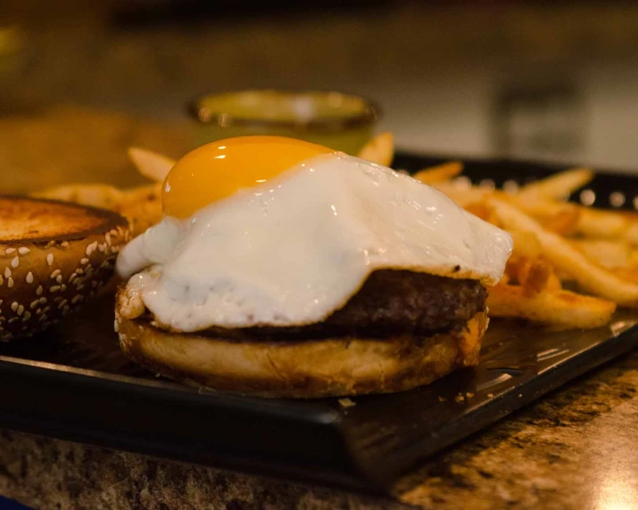 a plate with a hamburger and a fried egg