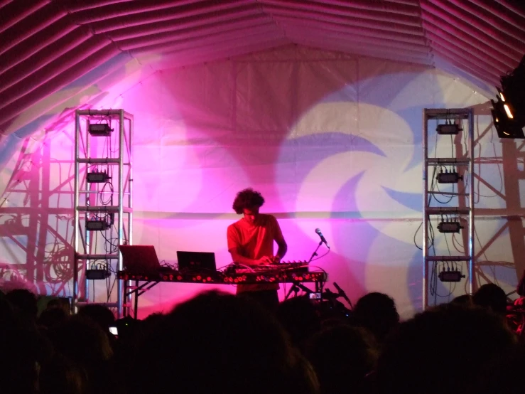 a person with a keyboard in front of a crowd