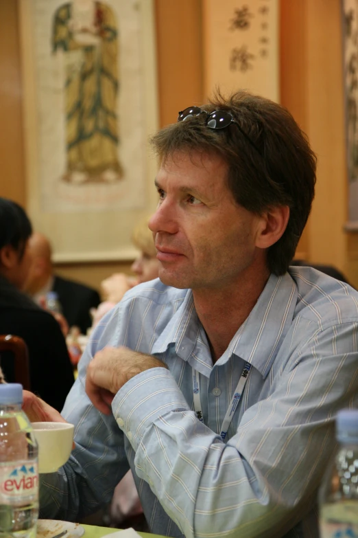 a man sitting at a table looking away from the camera