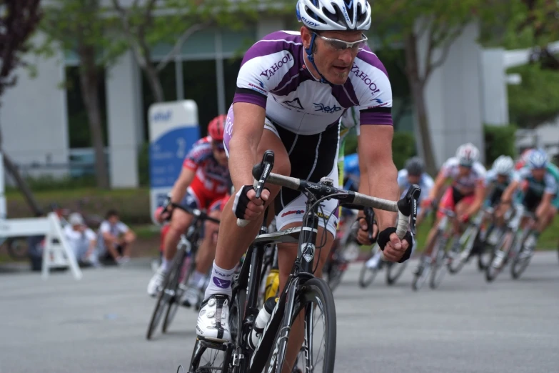 professional cyclists in motion with bibs on their backs