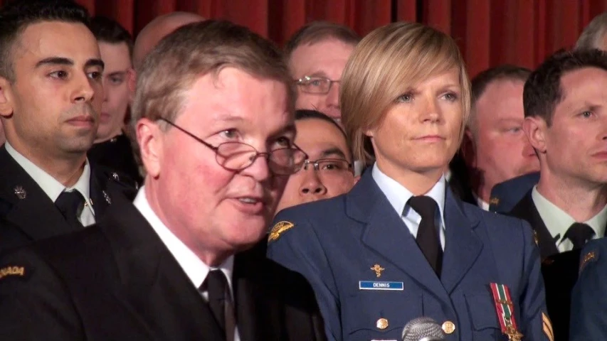 a group of people standing around a judge with microphone