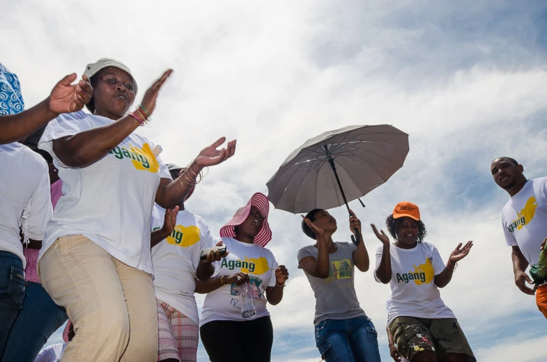 group of women standing in line holding umbrellas