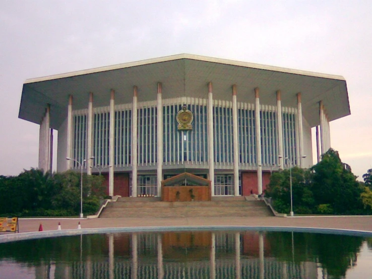 large building with an open front and stairs on each of it's sides