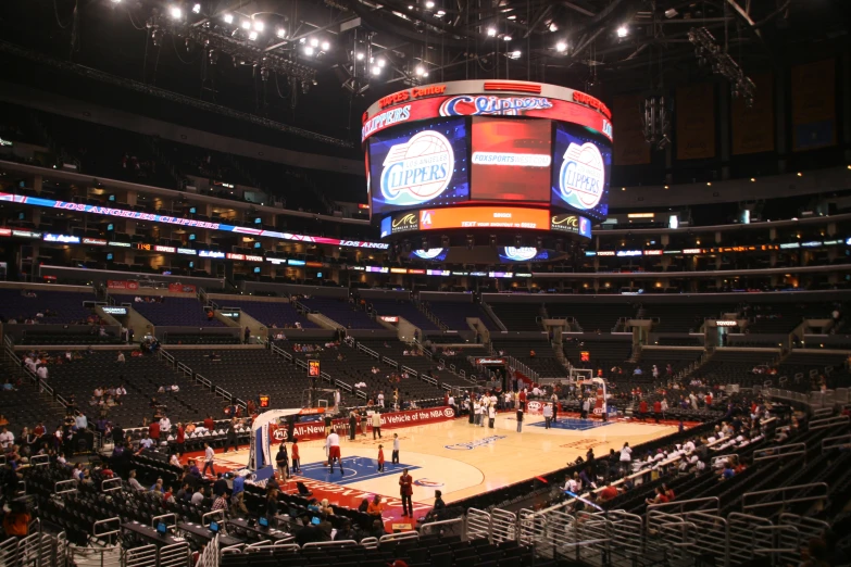 a large basketball court is shown in a darkened stadium