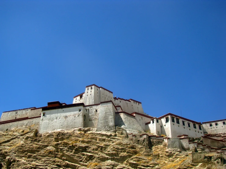 a large building on top of a rocky hill